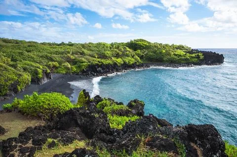 Dramatic Black Sand Beach and Volcanic Lava Coastline with Turquoise Ocean Stock Photos