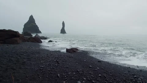 Dramatic Black Sand Beach of Reynisfjara with Reynisdrangar Sea Stacks, Iceland Stock Footage 320508826