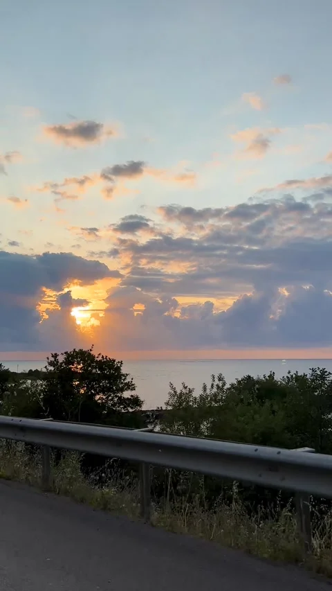 Dramatic Black Sea sunset landscape of glowing sky layered clouds orange gold Stock Footage 338114154