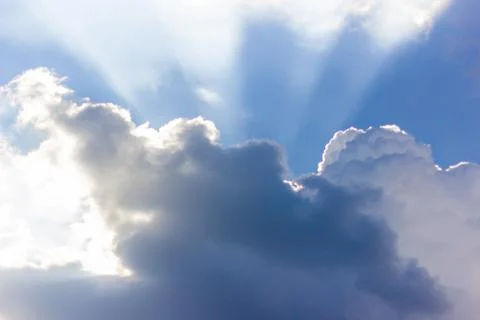 Dramatic blue sky with beautiful clouds and sun rays in the evening Photos