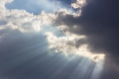 Dramatic blue sky with beautiful clouds and sun rays in the evening Stock Photos