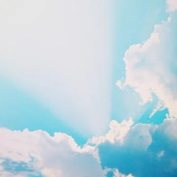 Dramatic blue sky with clouds and sunbeams, retro filter effect Stock-Fotos