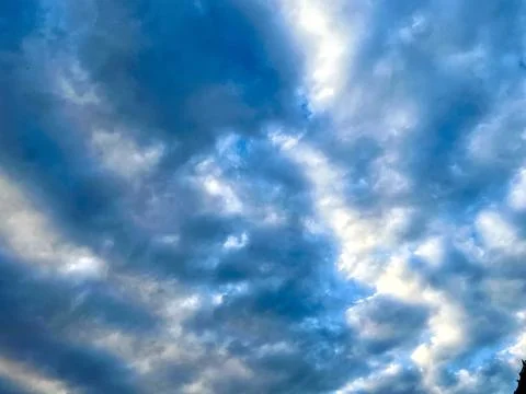 Dramatic Blue Sky Filled with Soft White Cumulus Clouds on a Bright Sunny Day Stock Photos