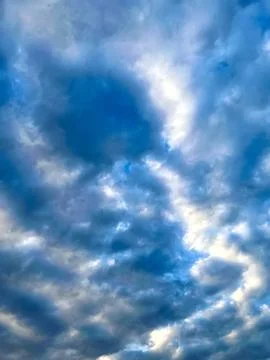 Dramatic Blue Sky Filled with Soft White Cumulus Clouds on a Bright Sunny Day Stock Photos