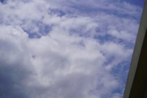 Dramatic blue sky with fluffy white clouds backdrop for agricultural or indus Stock Photos