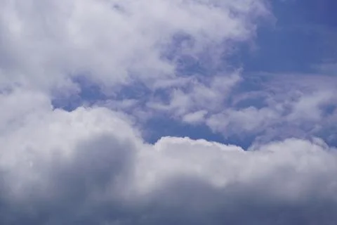 Dramatic blue sky with fluffy white clouds and soft sunlight for agricultural Stock Photos