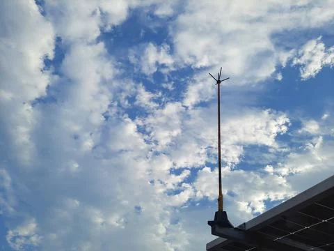 Dramatic Blue Sky with Fluffy White Clouds and Solar Panel Structure. 写真素材