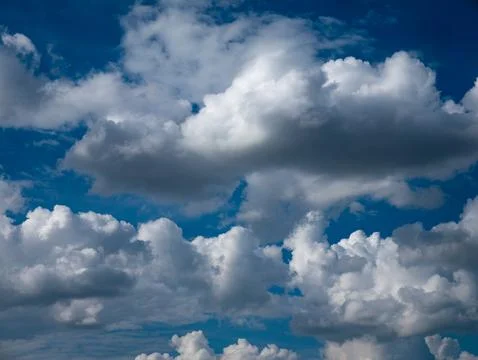 Dramatic Blue Sky Full of White Cumulus Clouds Formation Background Stock Photos