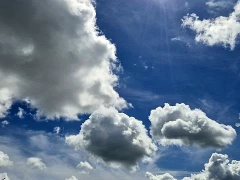 Dramatic blue sky with large white clouds Stock Photos