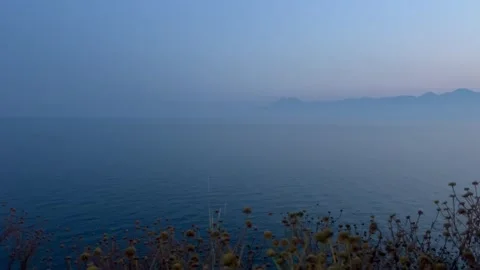 Dramatic blue sky over the blue sea during sunset Stock Footage 337025235