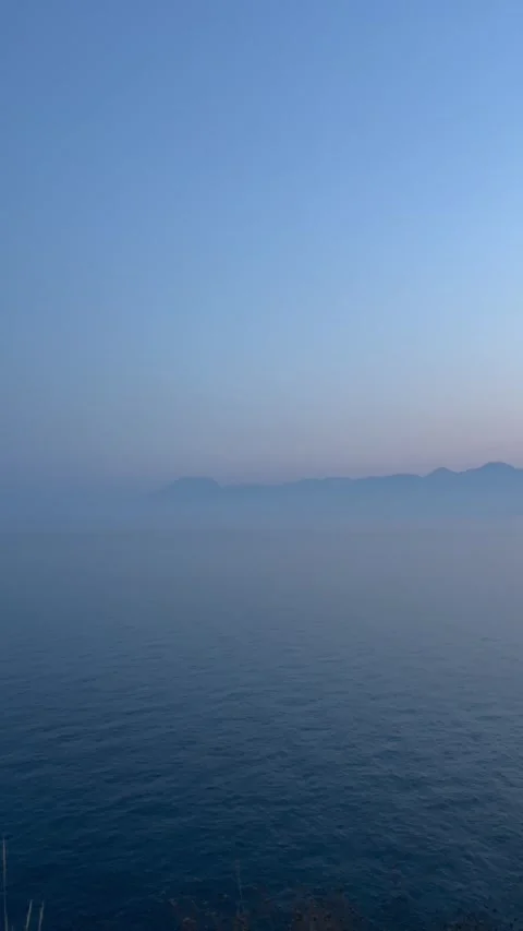 Dramatic blue sky over the blue sea during sunset Stock Footage 337025610