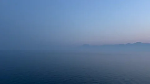 Dramatic blue sky over the blue sea during sunset Stock Footage 337025773