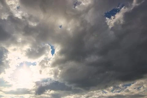 Dramatic blue sky with rays and white clouds Stock Photos