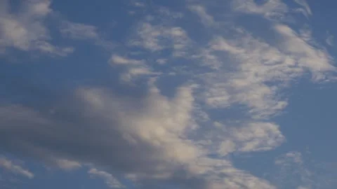 Dramatic Blue Sky with Scattered White and Golden Sunlit Clouds Stock Footage 340380827