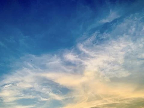 Dramatic Blue Sky with Soft Clouds and Warm Golden Sunset Light  Indonesia Stock Photos