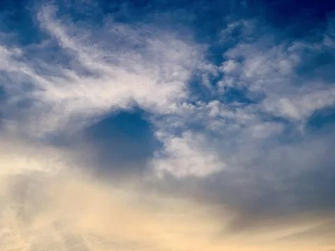 Dramatic Blue Sky with Soft Clouds and Warm Golden Sunset Light  Indonesia Stock Photos