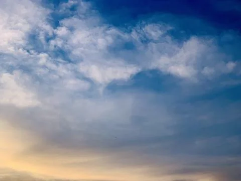 Dramatic Blue Sky with Soft Clouds and Warm Golden Sunset Light  Indonesia Stock Photos