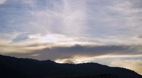 Dramatic Blue Sky with Soft White Clouds at Sunset Stock Photos