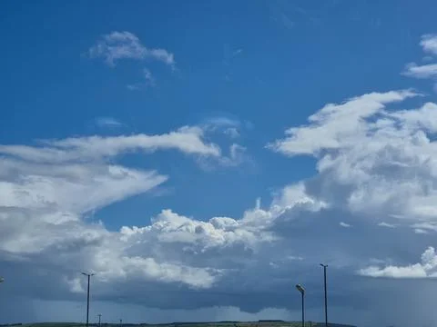 Dramatic blue sky with sunlit clouds and stormy weather Stock Photos