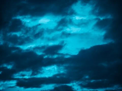 Dramatic Blue Storm Clouds with Surreal Light Texture Stock Photos
