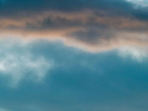 Dramatic Blue-Teal Storm Clouds with Warm Sunset Light Peeking Through Stock Photos