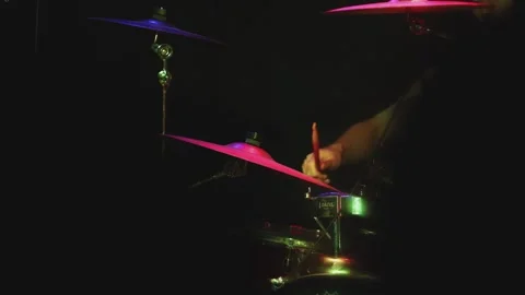 Dramatic blurred shot of a live concert scene when a drummer playing his Stock Footage 308359862