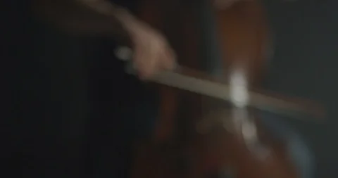 Dramatic bowing of cello strings at symphony close up Stock Footage 127580683