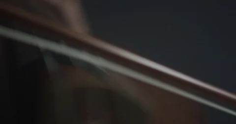 Dramatic bowing of cello strings at symphony close up Stock Footage 127580739