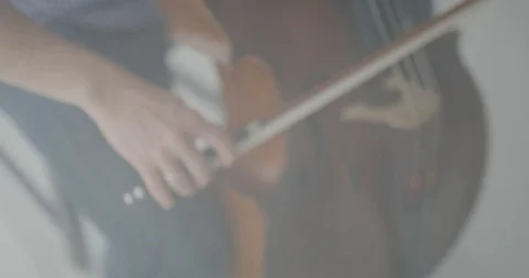 Dramatic bowing of cello strings at symphony close up Stock Footage 127580763