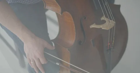Dramatic bowing of cello strings at symphony close up Stock Footage 127581140