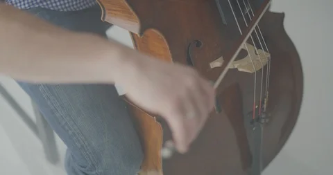 Dramatic bowing of cello strings at symphony close up Stock Footage 127581144
