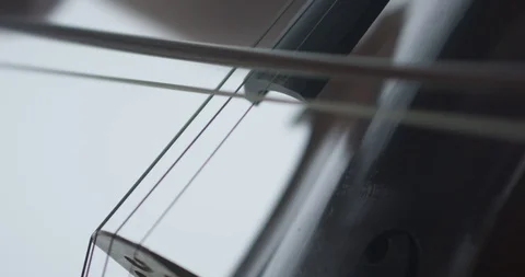Dramatic bowing of cello strings at symphony close up Stock Footage 127581305