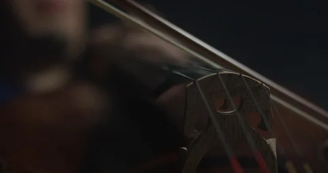 Dramatic bowing of cello strings at symphony close up Stock Footage 127581312