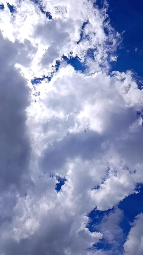Dramatic Bright White Clouds Passing in Blue Sky with Intense Sunlight Daytime Stock Footage 328486320