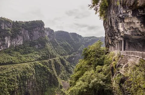 Dramatic Canyon Pass with Cliff-Hugging Walkway Carved into the Karst Forma.. Stock Photos