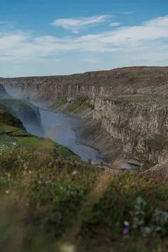 Dramatic Canyon with River and Rainbow in Iceland's Rugged Terrain Stock Photos