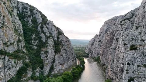 Dramatic Canyon River Between Rocky Cliffs at Sunset Stock Photos