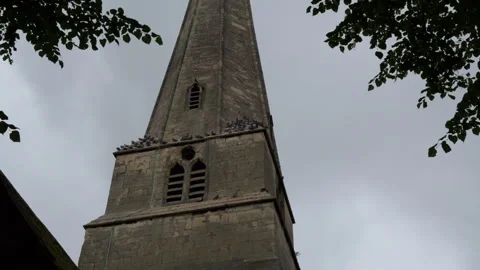 Dramatic cathedral tower view with pigeons on ledges and flying at dusk 스톡 동영상 328039249