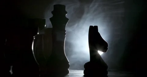 Dramatic Chess Pieces Illuminated in Shadowy Atmosphere Stock Footage 340078928