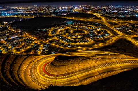 Dramatic City lights viewed from a mountain top. 写真素材