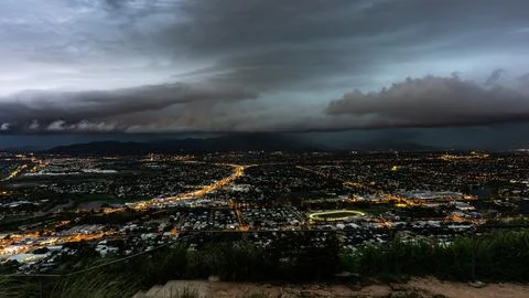 A Dramatic Cityscape Captured Under Stormy Clouds at Dusk with Intense Colo.. 스톡 사진