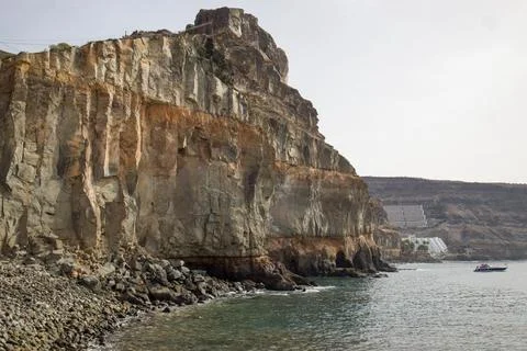 Dramatic cliff face on the coast of Gran Canaria. Layers of rock, ocean views Stock Photos