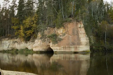 Dramatic cliff face with a dense forest overlooking a river or lake. Gudu cli Stock Photos