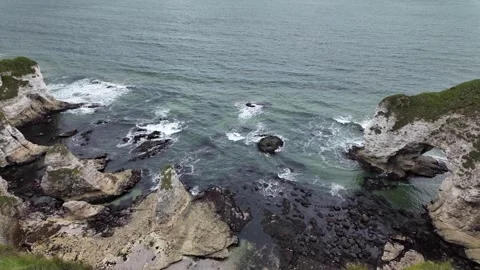 Dramatic Cliff Seascape with Waves and Natural Arch Northern Ireland Vídeos de archivo 317572789