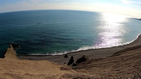 Dramatic cliff view of black sand beach and ocean in Iceland Stock Footage 333976178