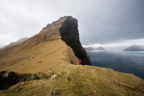 Dramatic cliff view over the stormy seas in a barren landscape, Faroe Islands Stock Photos