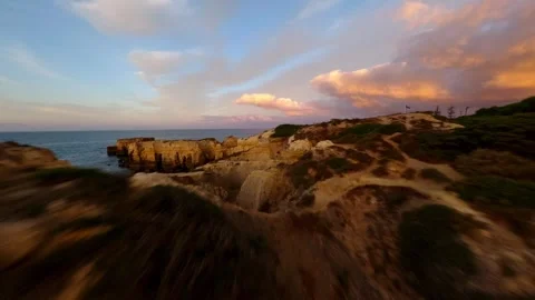 Dramatic cliffs meet ocean at golden hour Video stock 346091940