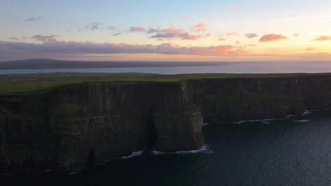 Dramatic Cliffs of Moher at Sunset with Pink Sky in Ireland Stock Footage 331828626