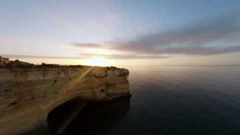 Dramatic cliffs overlook tranquil ocean at dusk Video stock 346091353