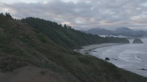 Dramatic Cliffs Overlooking the Pacific Ocean at sunrise, Canon Beach Video stock 332255154